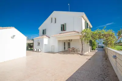 a white house with a fence next to it at Protaras Holiday Villa Jo78 in Paralimni