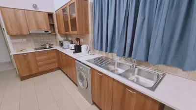 a kitchen with a sink and a washing machine at STAY Mythos Down Town House in Nicosia