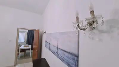 a dining room with a painting on the wall at STAY Mythos Down Town House in Nicosia
