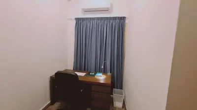 a desk in a room with a blue curtain at STAY Mythos Down Town House in Nicosia
