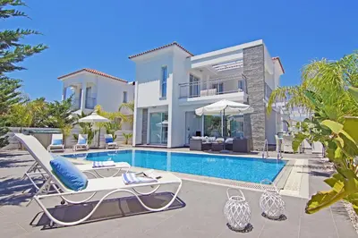 a villa with a swimming pool and a house at Villa Solebianco Protaras in Protaras