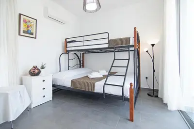 a bedroom with a bunk bed in a room at Villa Solebianco Protaras in Protaras