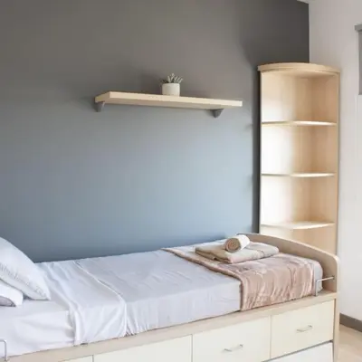 a bedroom with a bed with a blue wall at Villa Artemis in Larnaka