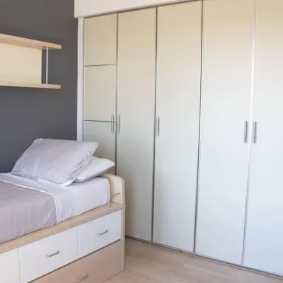 a bedroom with white cabinets and a bed at Villa Artemis in Larnaka