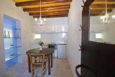 a kitchen with a table and chairs in a room at Palatakia - Adults Only in Kato Drys