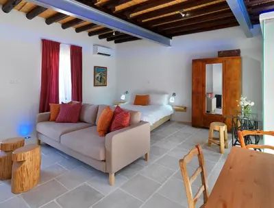 a living room with a couch and a bed at Palatakia - Adults Only in Kato Drys