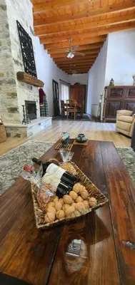 a tray of food on a wooden table in a living room at Bougainvillea House Lefkara in Pano Lefkara