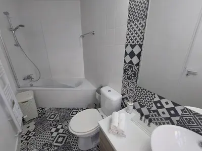 a bathroom with a toilet and a sink and a tub at Bougainvillea House Lefkara in Pano Lefkara