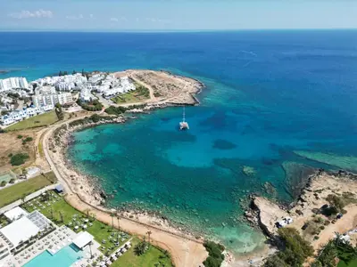 an aerial view of a beach with a boat in the water at Zoe's villa by Turtle Bay in Protaras