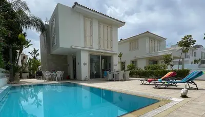 a house with a swimming pool in front of a house at Zoe's villa by Turtle Bay in Protaras