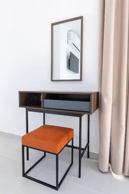 a dressing table with a mirror and a stool at Nelia Panorama Villa in Protaras