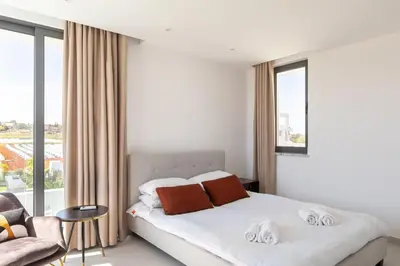a bedroom with a bed and a large window at Nelia Panorama Villa in Protaras