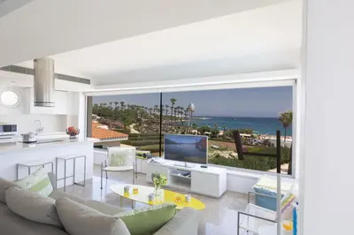 a kitchen and living room with a view of the ocean at Protaras Thalassa Apartment Ta206 in Protaras