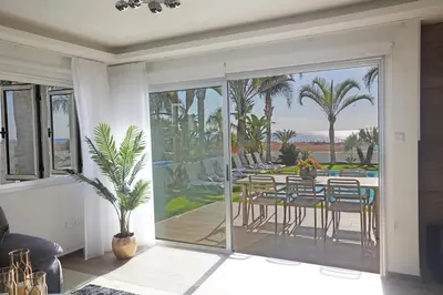 a living room with a balcony with a table and chairs at Sunrise Villa 9 in Ayia Napa