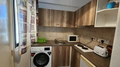 a small kitchen with a washing machine and a sink at Ayia Napa Cyprus in Paralimni