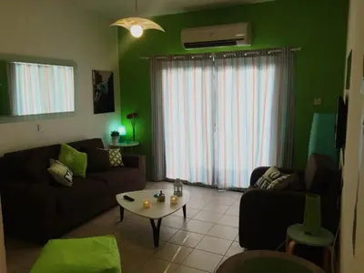 a living room with a couch and a table at Ayia Napa Cyprus in Paralimni