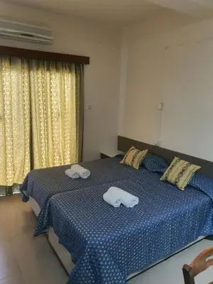 a bedroom with a bed with two towels on it at Eleni Apartments in Ayia Napa