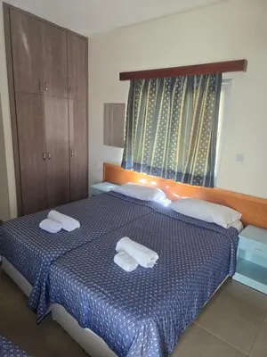 a bedroom with a bed with two towels on it at Eleni Apartments in Ayia Napa