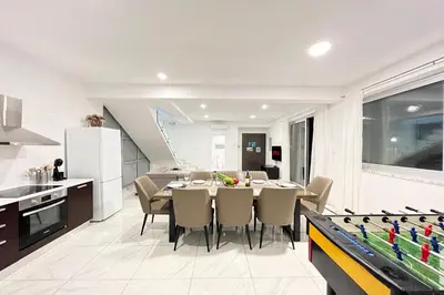 a kitchen and dining room with a table and ping pong ball at Villa Selena in Protaras