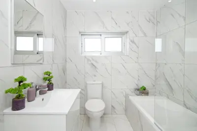 a white bathroom with a toilet and a tub and a sink at Villa Selena in Protaras