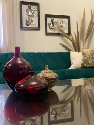 two vases sitting on a table in a living room at Oikos Selinolithos in Alaminos