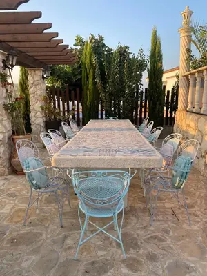 a long table and chairs on a patio at Oikos Selinolithos in Alaminos