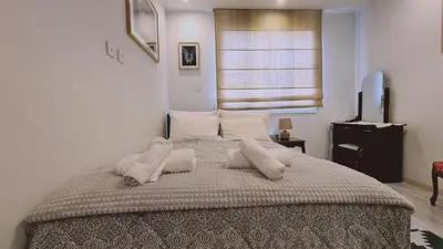a bedroom with a large bed with pillows on it at STAY Serenity Apartment in Yukarı Lakatamya