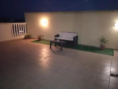 a patio at night with a couch and a table at Xylophagou Rest and Relax 2 Ayia Napa Larnaca 1 bedroom apartment in Xylophaghou