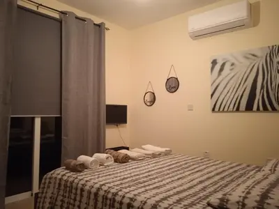a bedroom with a bed with towels on it at Xylophagou Rest and Relax 2 Ayia Napa Larnaca 1 bedroom apartment in Xylophaghou