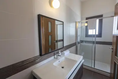 a white bathroom with a sink and a mirror at Protaras Holiday Villa Pa7 Private 7 Bedroom villa in Protaras