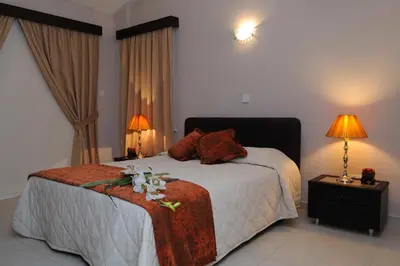 a bedroom with a bed with flowers on it at Three bedroom villa with private pool and landscaped garden close to the beach in Pissouri