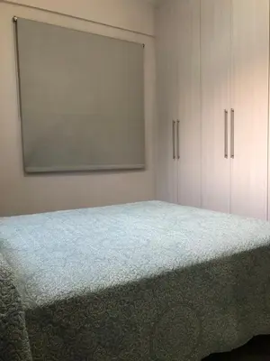 a bedroom with a bed and white cabinets at Great Views Apartment II in Limassol