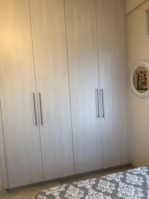 a bedroom with white cabinets and a bed at Great Views Apartment II in Limassol