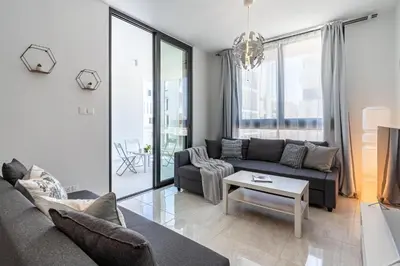 a living room with a couch and a table at Lana 1-Bedroom Apt in Larnaca in Larnaka
