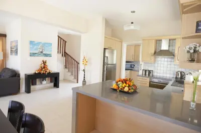 a kitchen with a bowl of fruit on a counter at A three-bedroom villa with a private pool and landscaped garden Wi-Fi in Pissouri