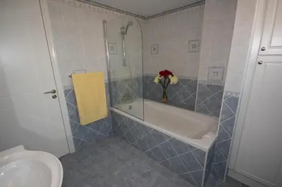 a bathroom with a tub and a toilet and a sink at A three-bedroom villa with a private pool and landscaped garden Wi-Fi in Pissouri
