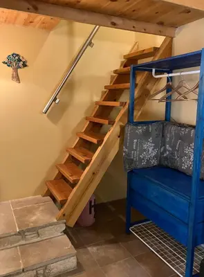 a staircase in a room with a bunk bed at Guesthouse Gonia in Pera Orinis