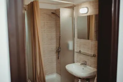 a bathroom with a sink and a shower at Ovis Hotel Apartments in Ayia Napa