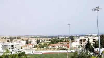 a city with a soccer field and buildings at Marina Court Holiday Flat in Larnaka
