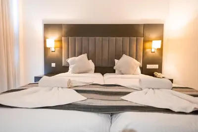 a large bed with two white pillows on it at Napa Jay Hotel in Ayia Napa