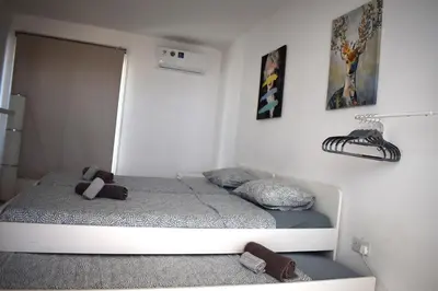 a bedroom with two beds and a mirror on the wall at Sunny Rooftop in Ayia Napa 91Sqm Terrace Delight! in Ayia Napa