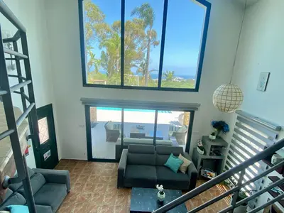 a living room with a couch and some windows at Mediterranean View Villa in Protaras