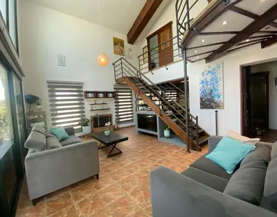 a living room with two couches and a staircase at Mediterranean View Villa in Protaras