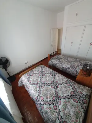 a bedroom with two beds and a rug on the floor at Indie7house in Pano Lefkara