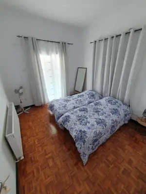 a bedroom with a bed and a wooden floor at Indie7house in Pano Lefkara