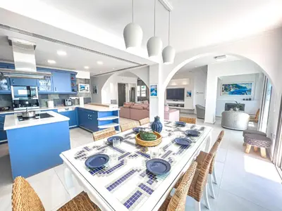 a kitchen and dining room with a table and chairs at Erato Seafront Luxury Villa in Protaras