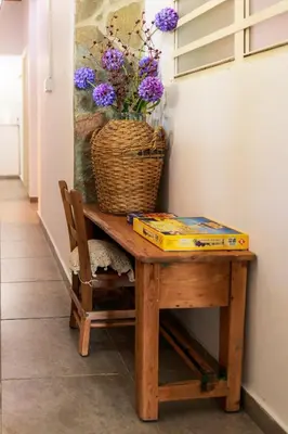 a table with a vase of purple flowers on it at Stella's Country House in Prodromos