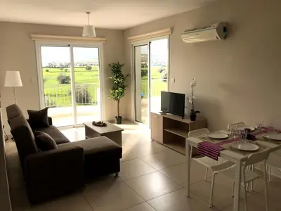 a living room with a couch and a table at Oceania Bay Penthouse in Pyla