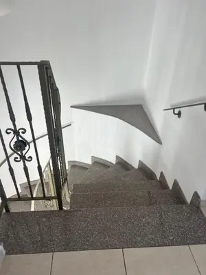 a staircase with a metal railing and a stair case at Chara Cynthiana Villa in Paralimni