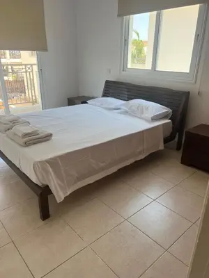 a bed with white sheets and pillows in a bedroom at Chara Cynthiana Villa in Paralimni